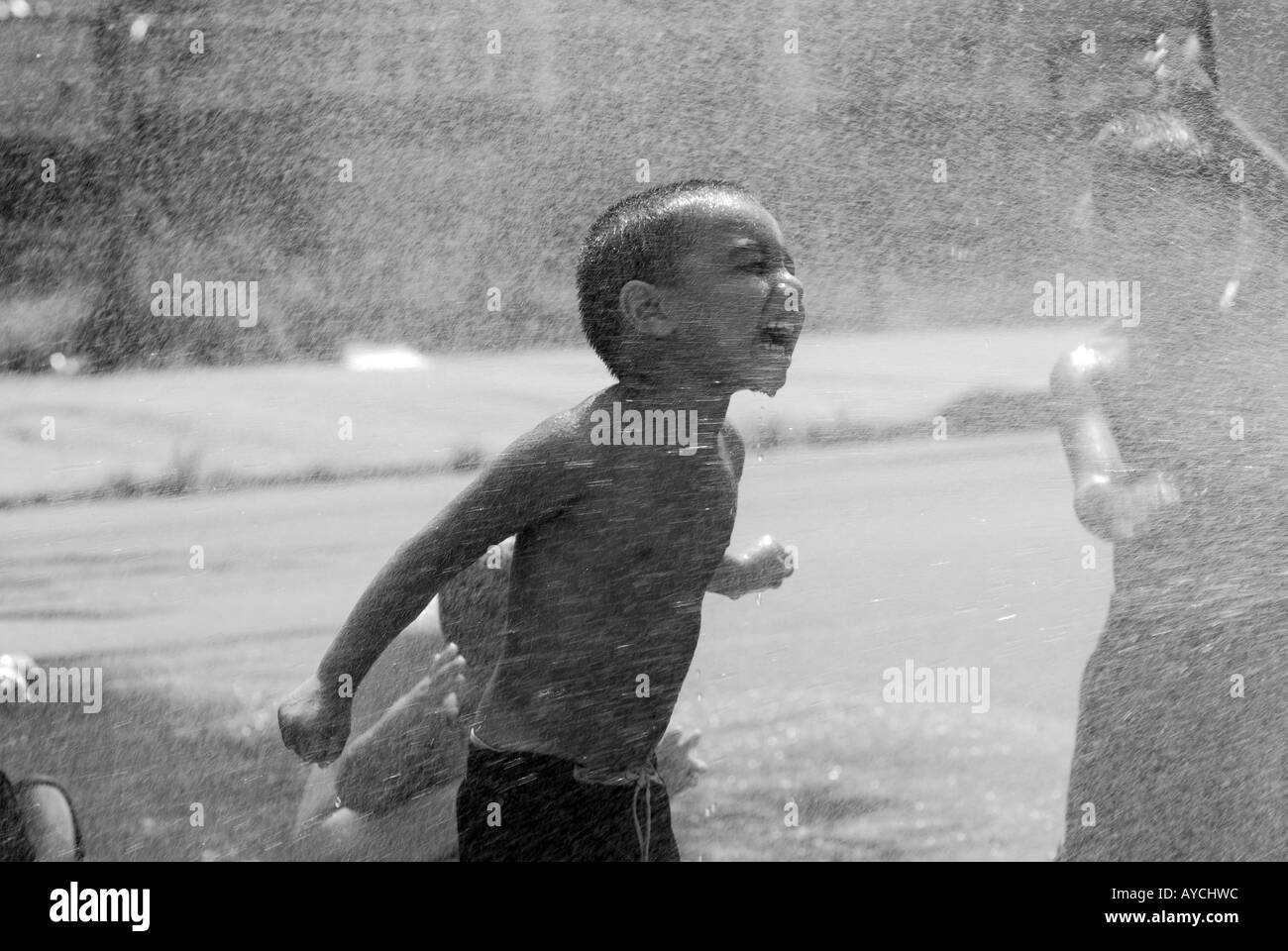 Child cooling off during summer heat wave in an urban city global