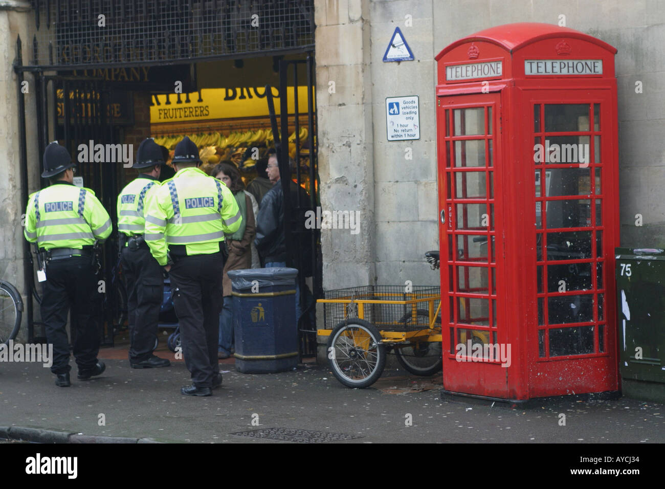 Police Entering The Covered Market In Oxford England Passing A English Telephone Box On The Way Stock Photo Alamy