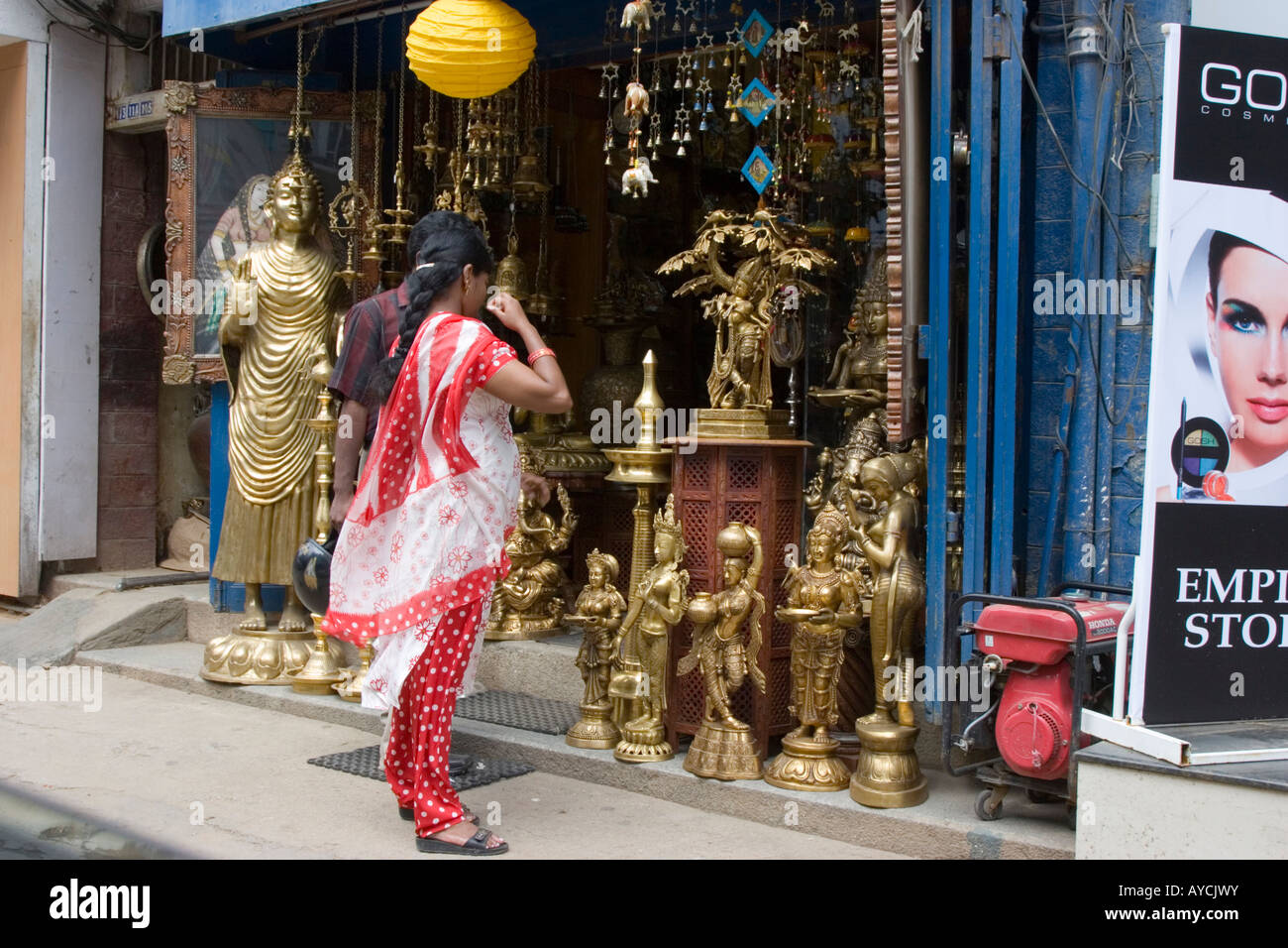 Looking at brass ornaments in a shop on MG Road Bangalore India Stock