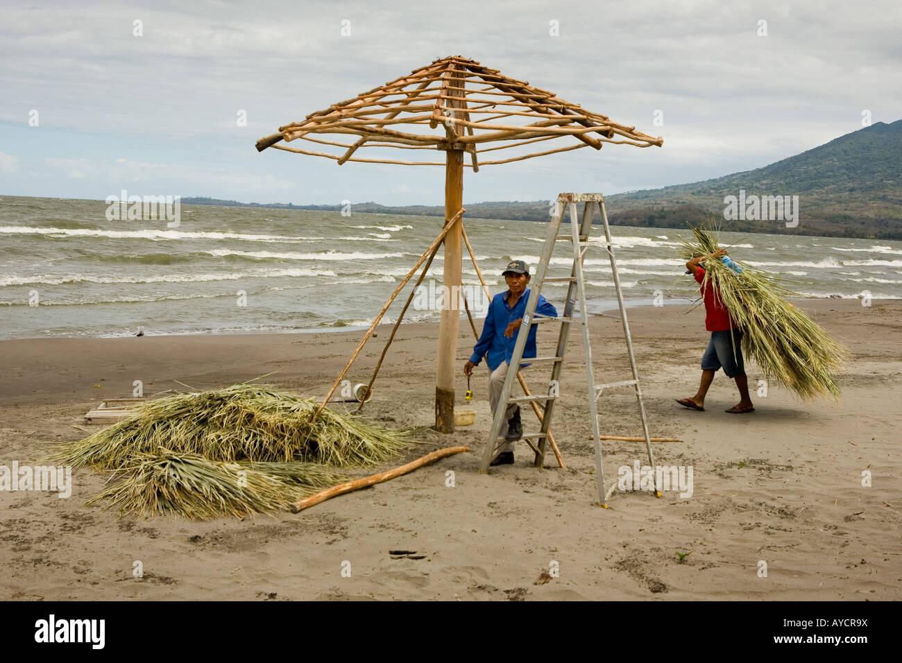 Making a thatched shelter on the beach Playa Santo Domingo Ometepe Island Nicaragua Stock Photo