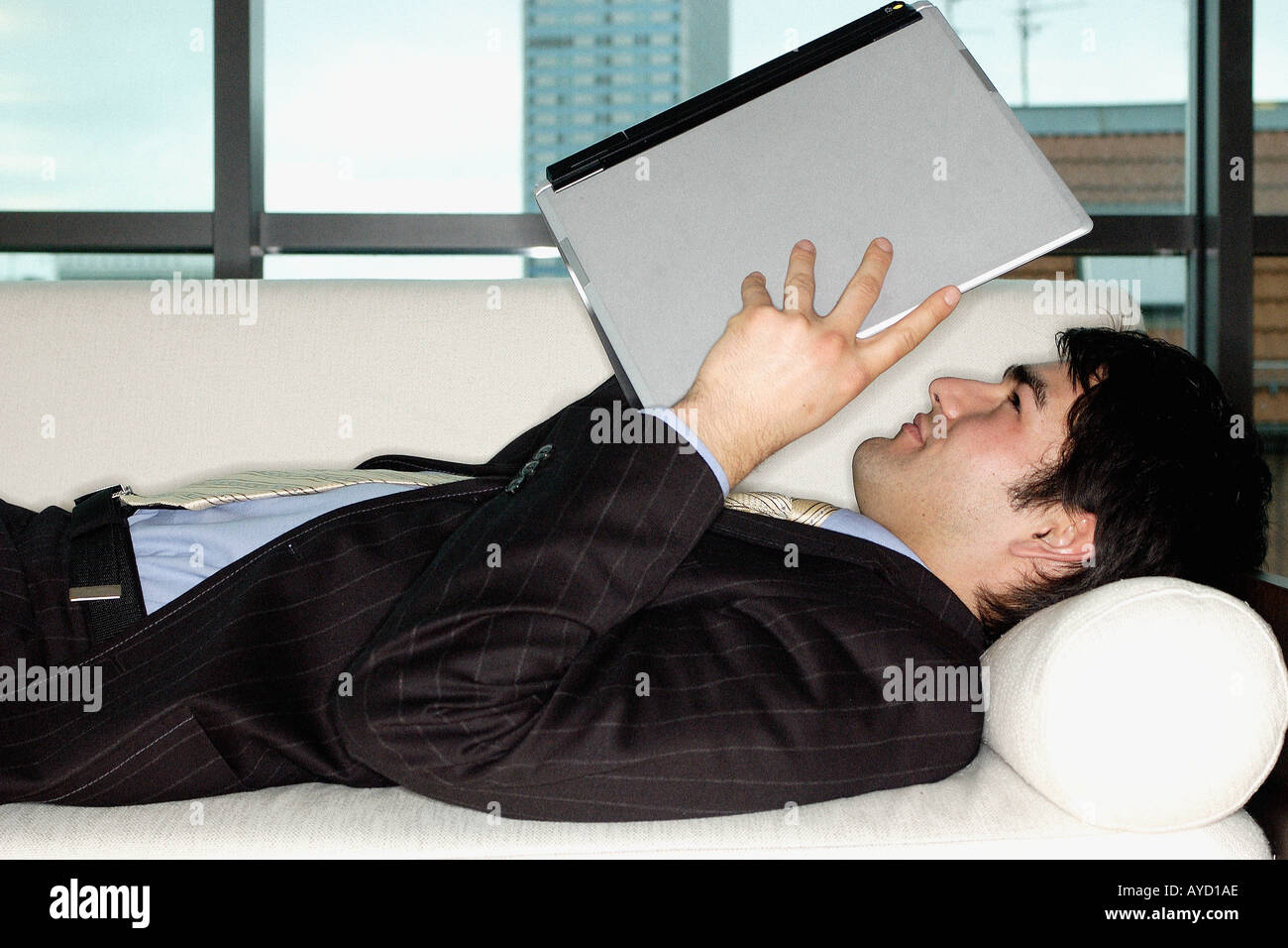 Businessman holding laptop computer Stock Photo - Alamy