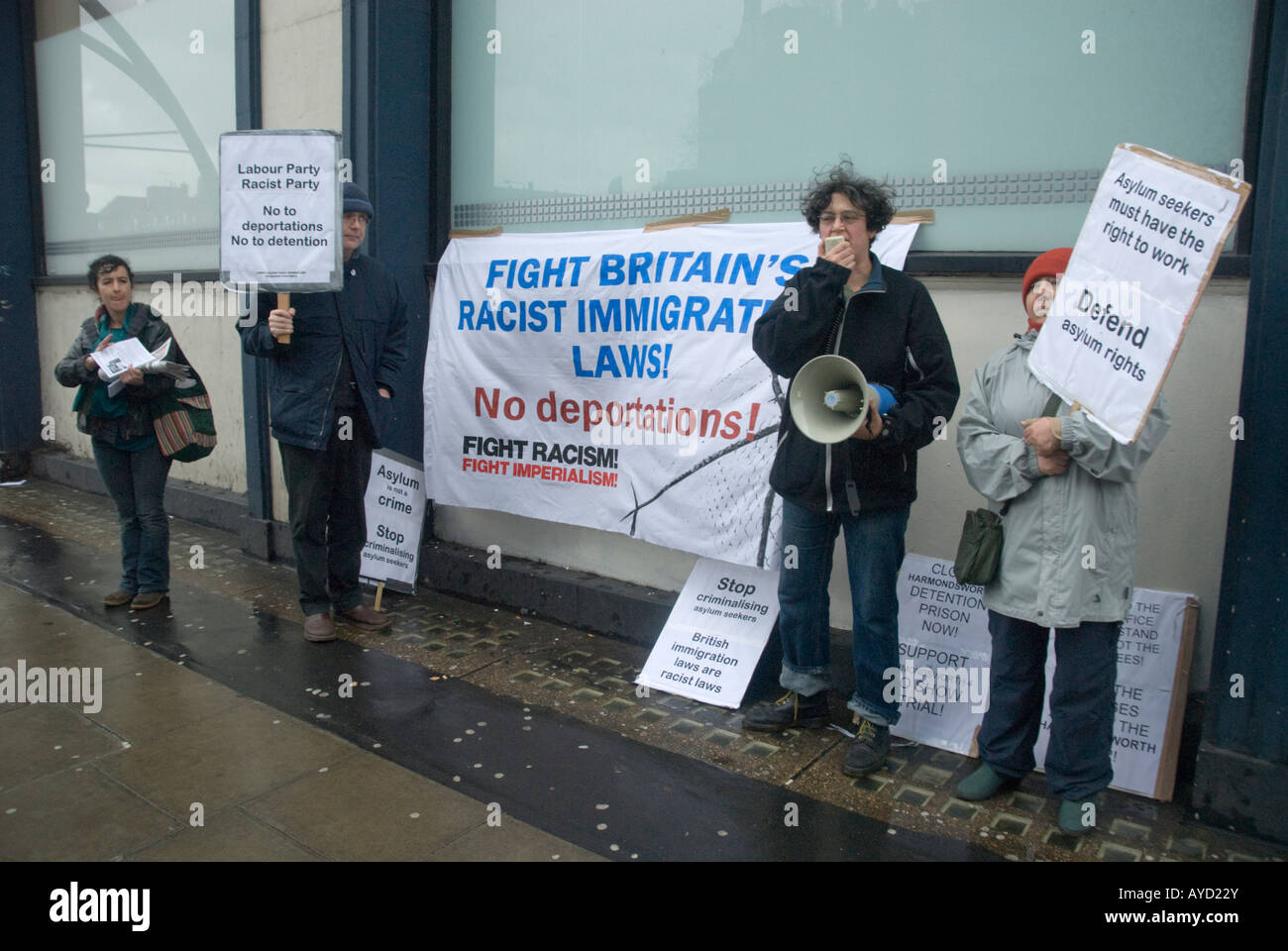 Protesters with placards and banners call for rights for asylum seekers