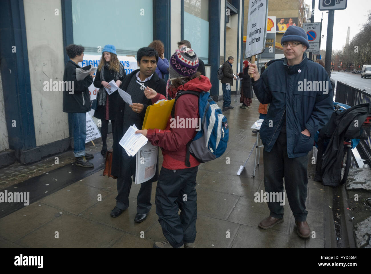 Protesters hand out leaflets and call for rights for asylum seekers in