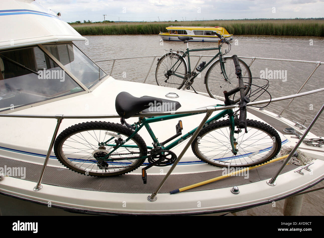 UK Norfolk Broads Reedham bikes stowed on prow of boat on River Yare Stock Photo
