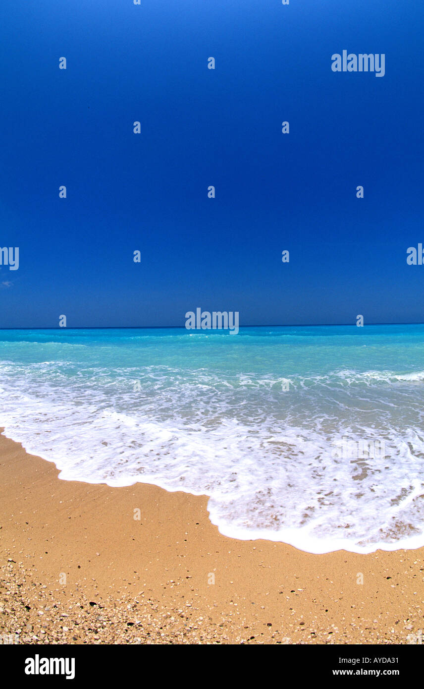 Tropics ideal perfect beach blue green ocean water blue sky background Stock Photo