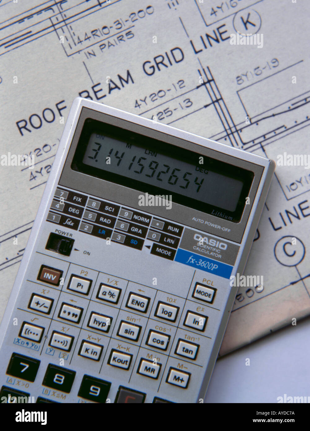 Construction industry; programmable pocket LCD (liquid crystal display) calculator and engineering drawings. Stock Photo