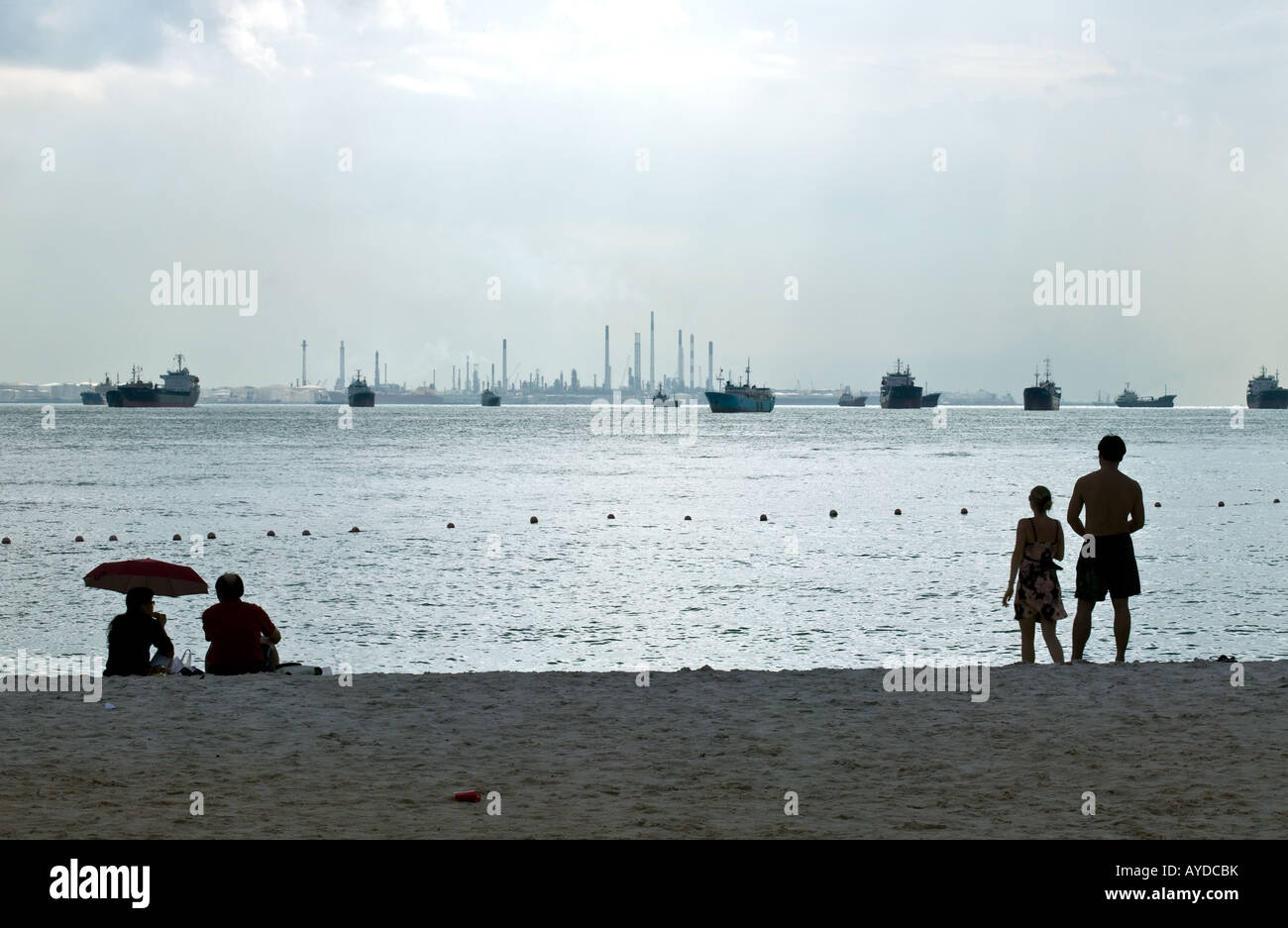 Sentosa beach with view of oil refinery Stock Photo