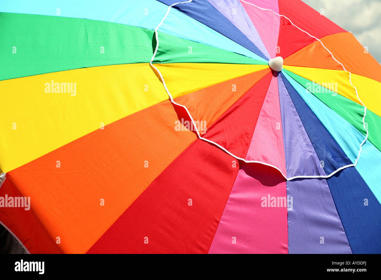 large rainbow colored beach umbrella closeup Stock Photo Alamy