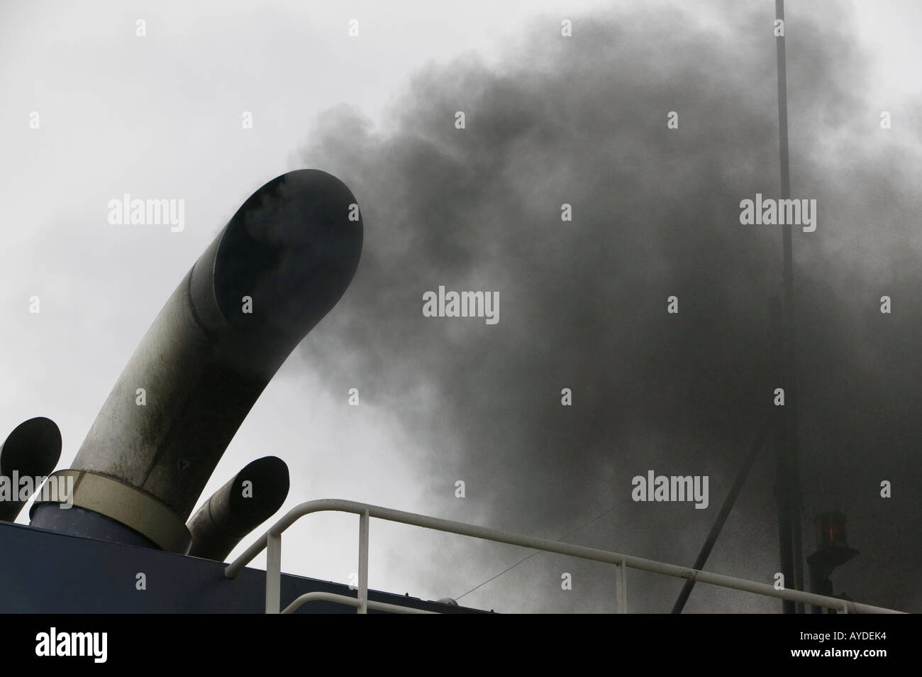 diesel fumes belching from a fishing vessel exhaust, Lochinver, scotland, UK Stock Photo