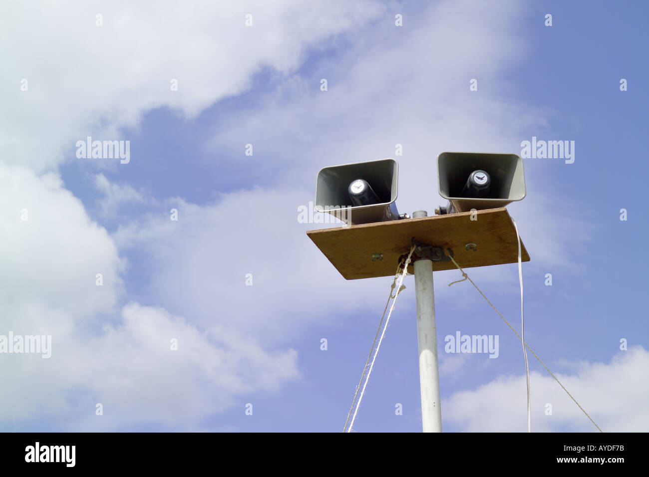 Loudspeakers on a pole with sky in the background at a fete Stock Photo