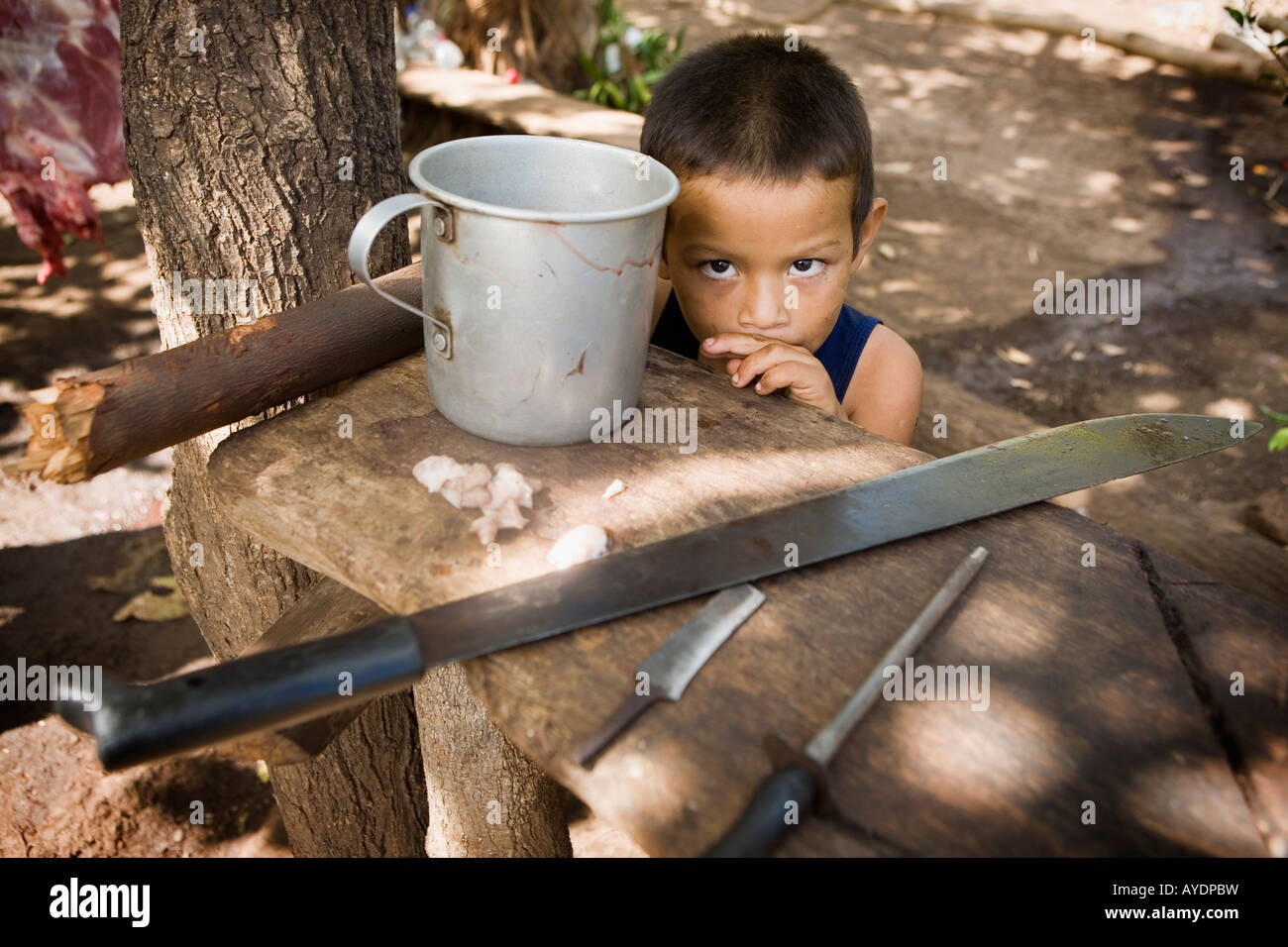 Little boy and father's butchering tools Ometepe Island Nicaragua Stock Photo