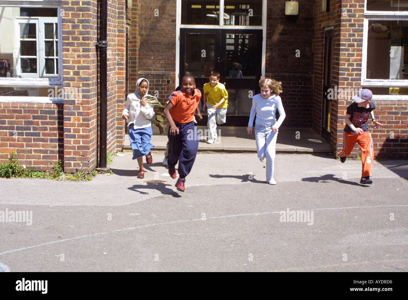 Primary School Children Running Out The School Doors After Lessons