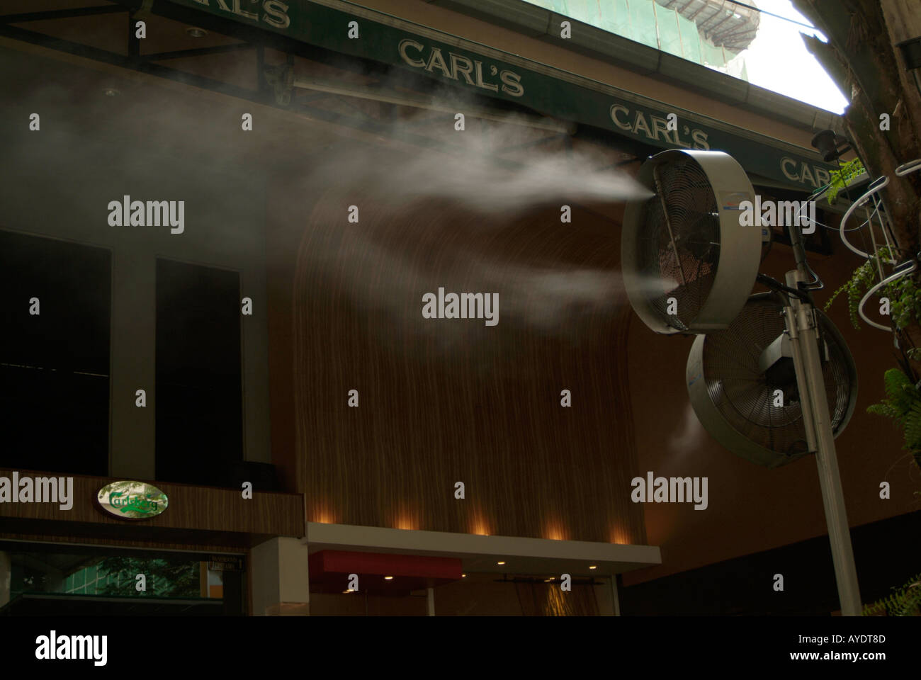 humidity, humid, heat, hot, weather, cool. water, fan, out side, a bar, in Kuala, Lumpur, Malaysia, Malaysian, spray, cooling, v Stock Photo