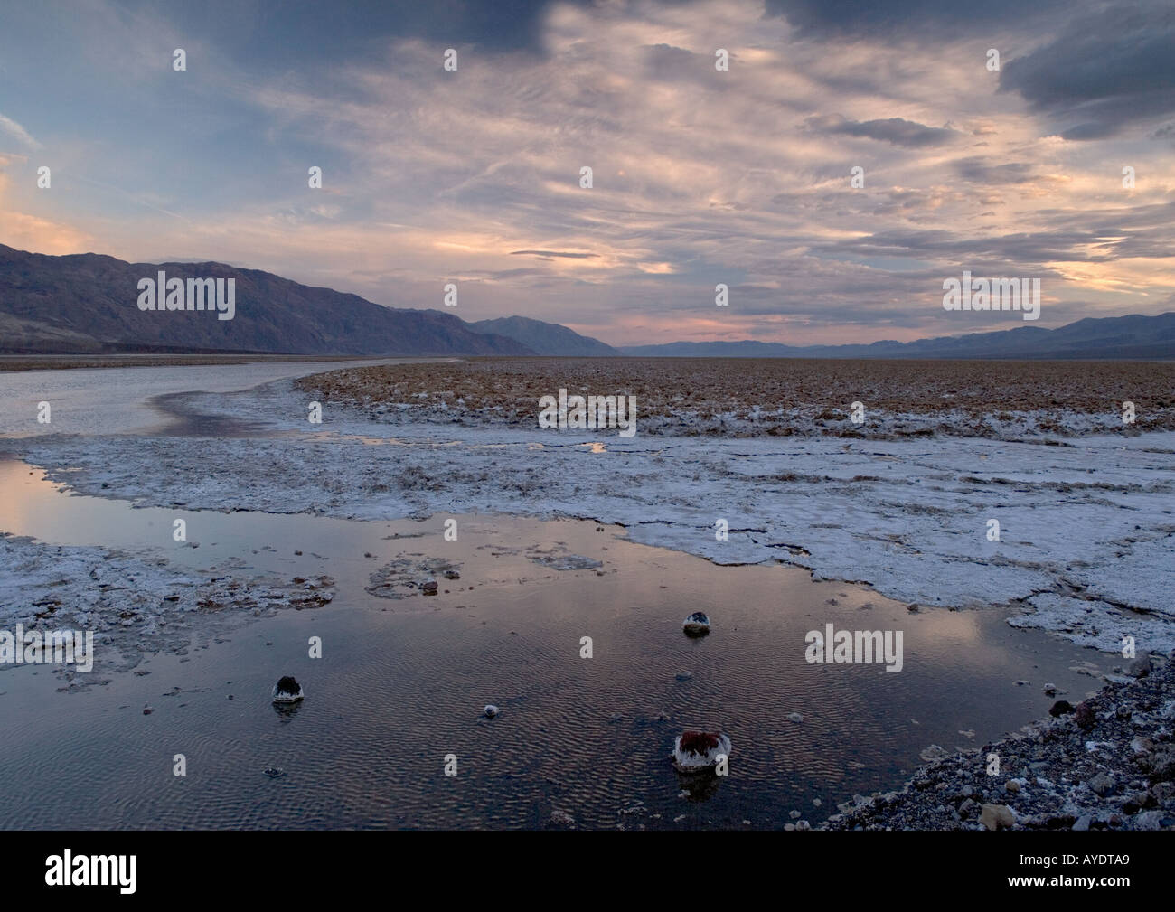 Salt lake in Death Valley National Park at sunset unusually full of water in high rainfall El Nino year, California USA Stock Photo