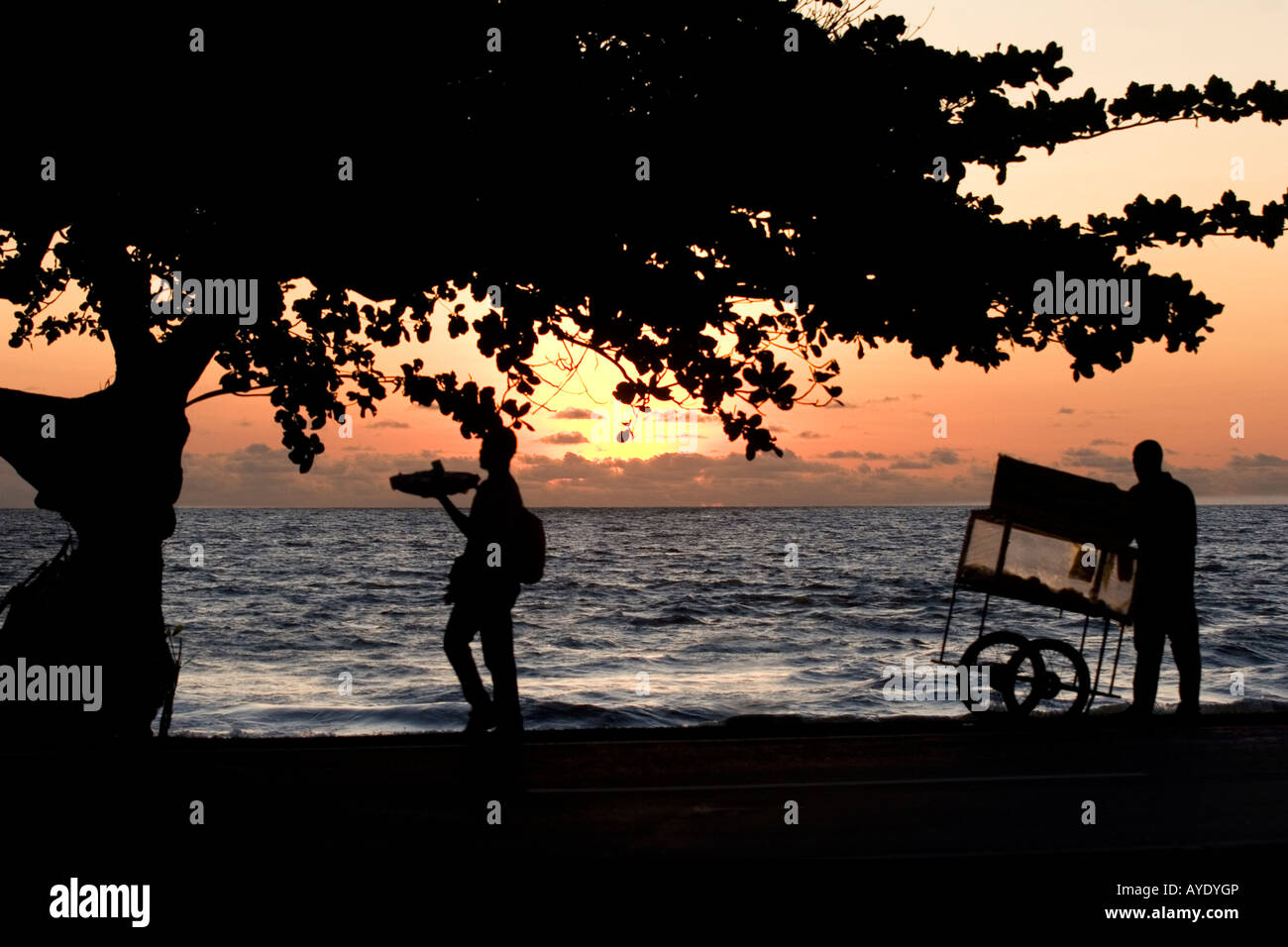 African street hawkers selling food at sunset on the beach waterfront at end of the day, Libreville, Gabon Stock Photo