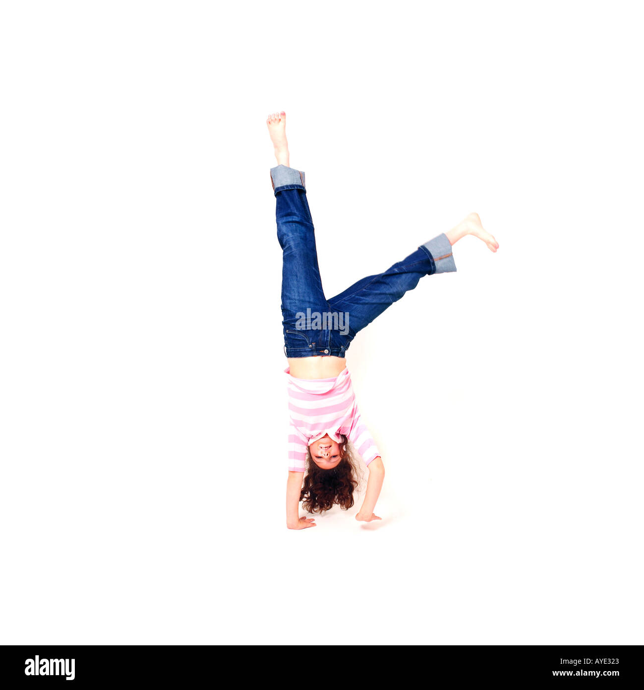 Girl doing cartwheel on white background Stock Photo
