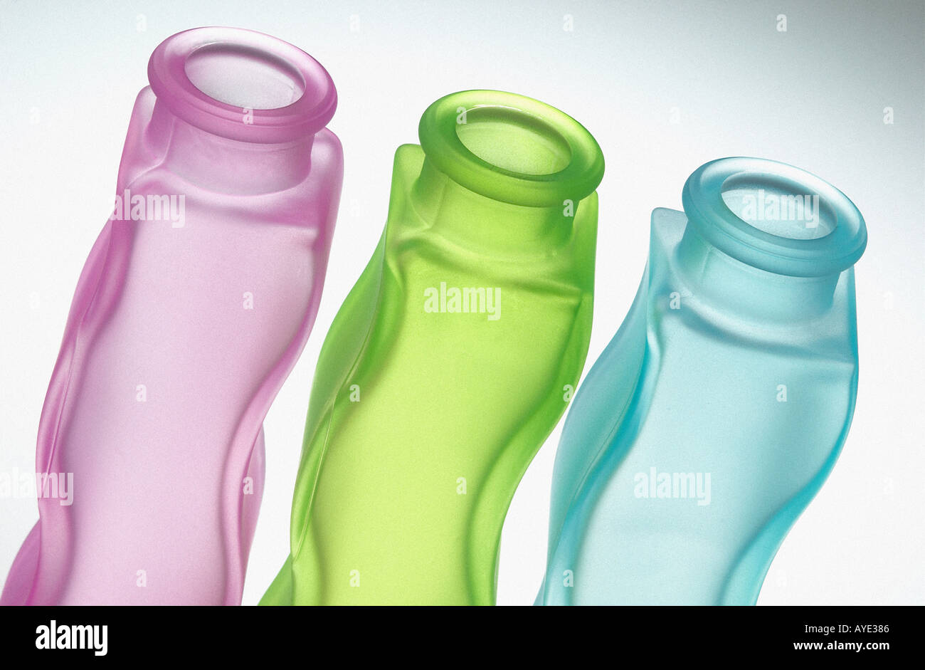 three coloured glass bottles Stock Photo