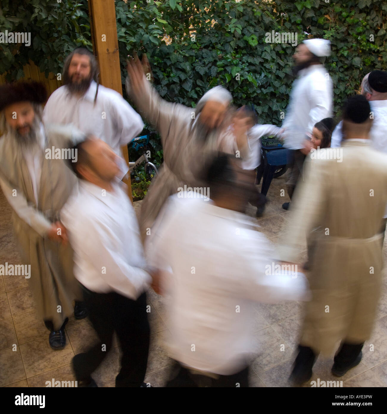 Israel Jerusalem Mea Shearim Orthodox neighbourhood group of men dancing together in a caroussel Stock Photo
