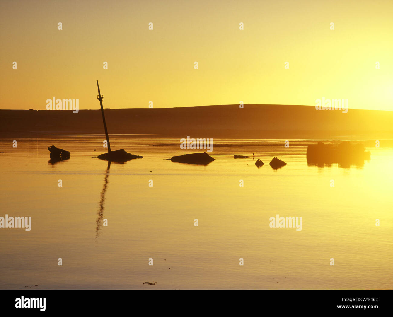 dh 2nd Churchill Barrier SCAPA FLOW ORKNEY Block ship wreckage sunk anti submarine defence barriers scotland sunset orange sky wreck sunken historical Stock Photo