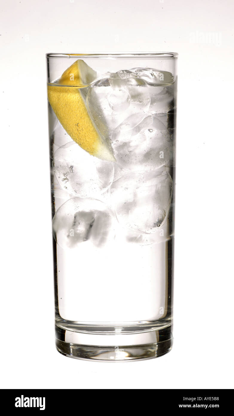 Glass of sparkling mineral water with ice and a lemon Stock Photo - Alamy