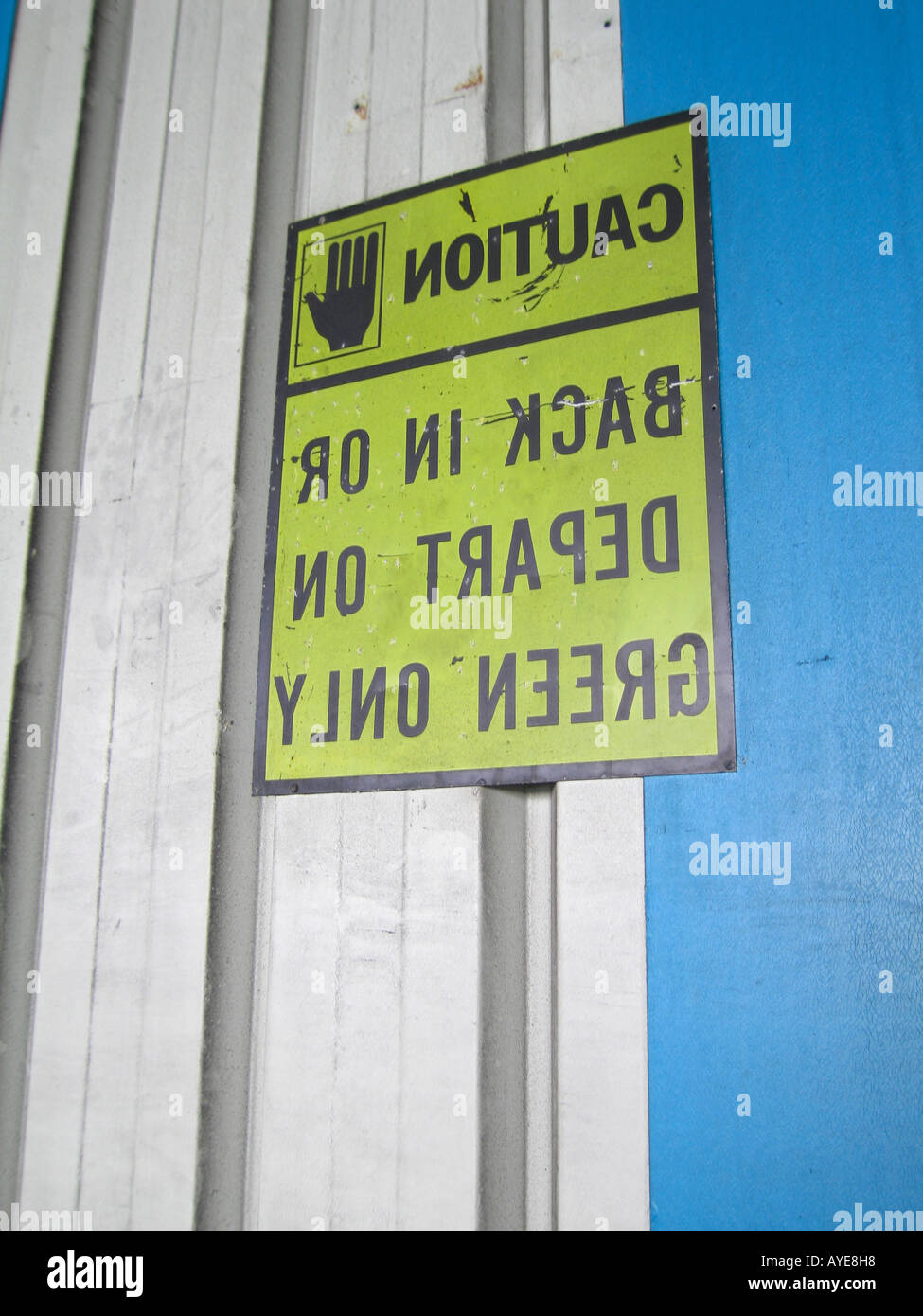 Mirror image sign on warehouse for viewing in truck rear view mirror Stock Photo