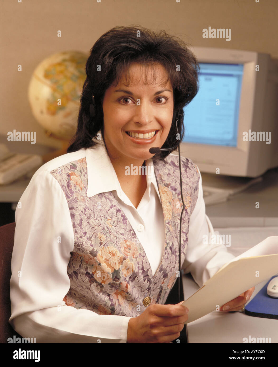 hispanic businesswoman working in office with headset Stock Photo