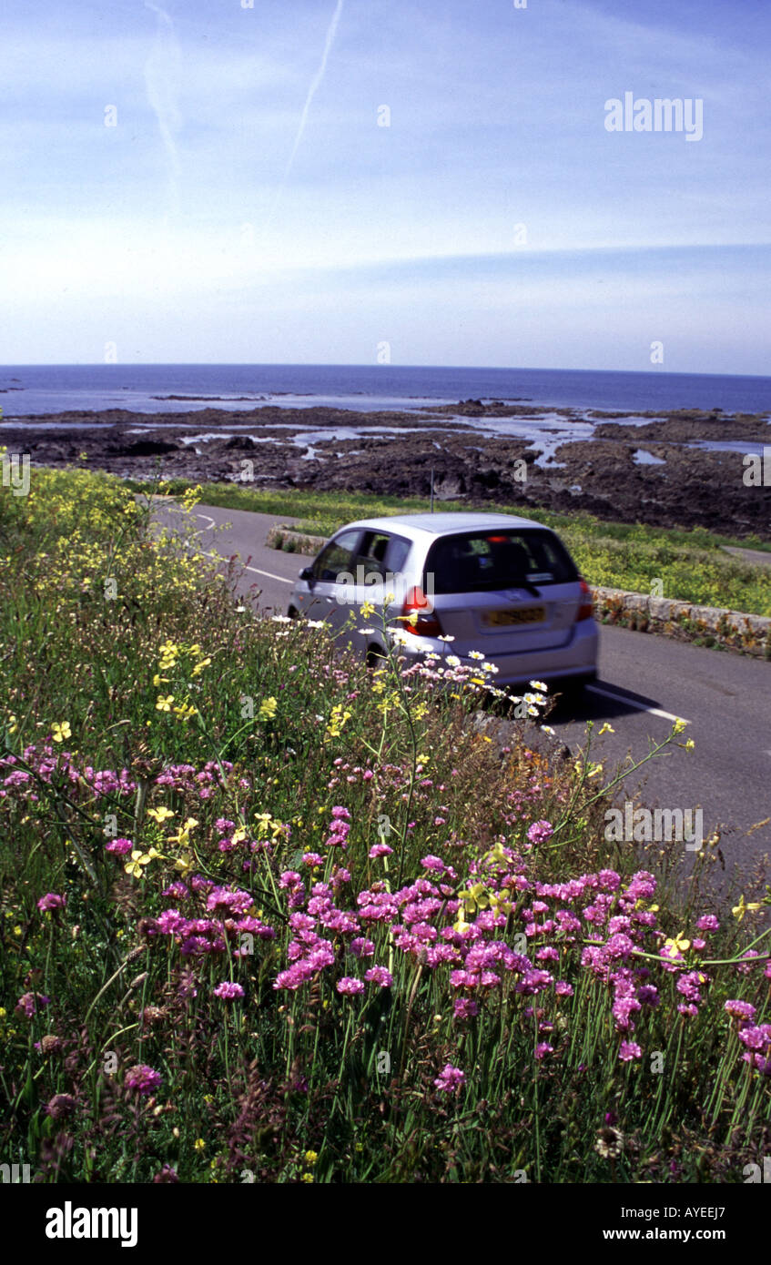 Tourists driving along coast road, Jersey, Channel Islands Stock Photo