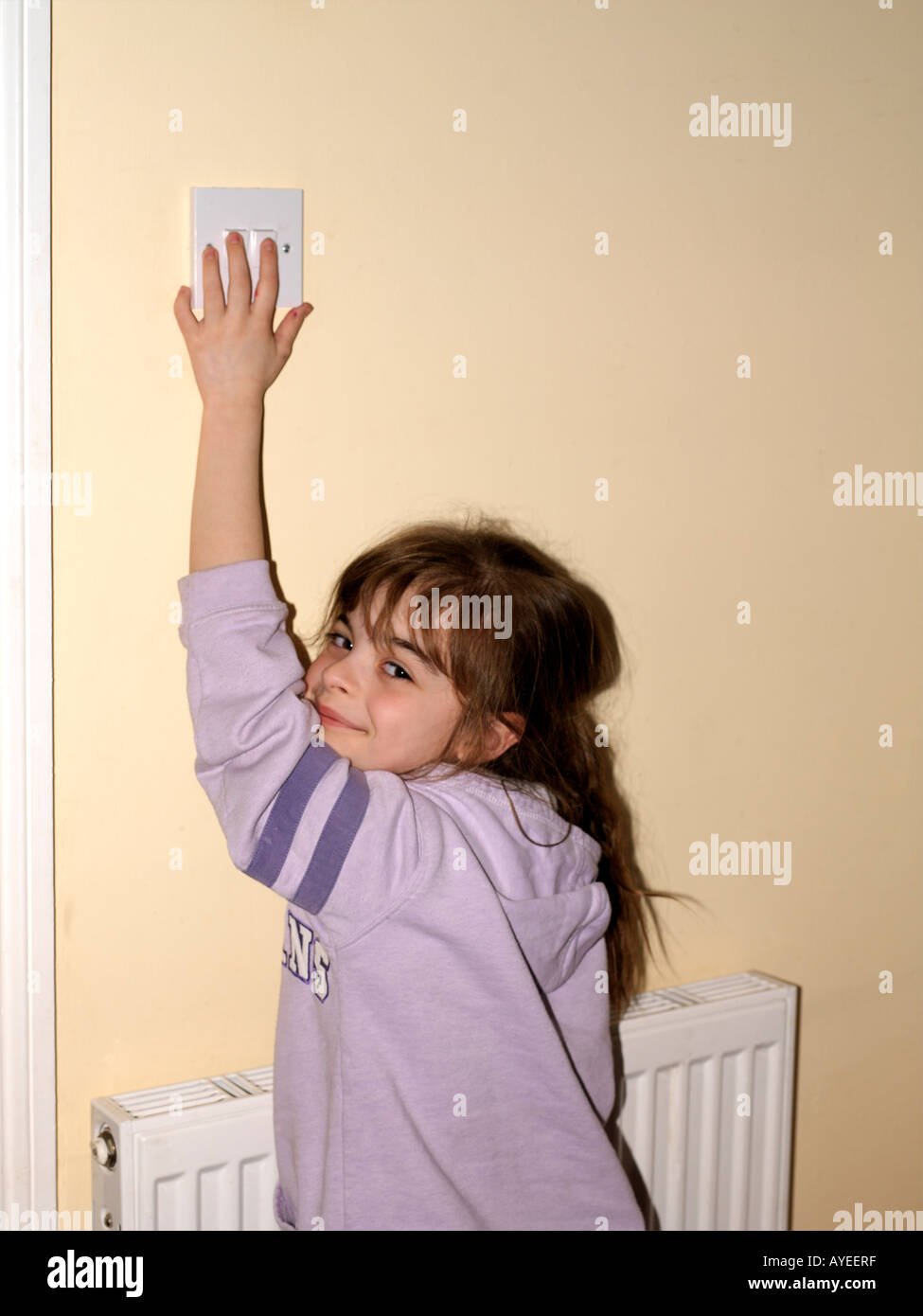 Nine Year Old Child Turning Off a Normal Lightswitch Stock Photo Alamy