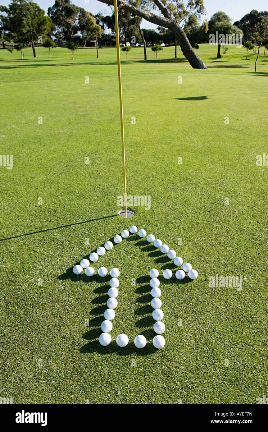 An arrow pointing to a hole on a golf green Stock Photo