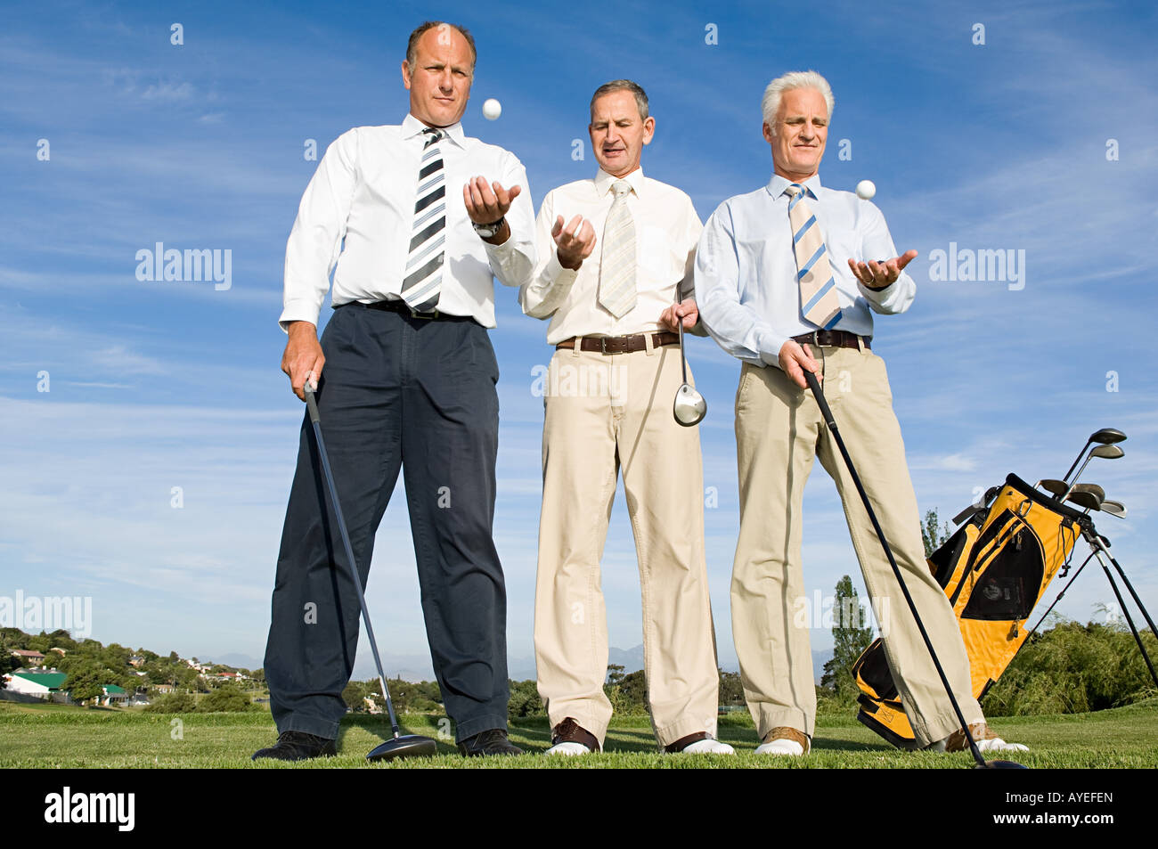 businessmen throwing golf balls Stock Photo Alamy