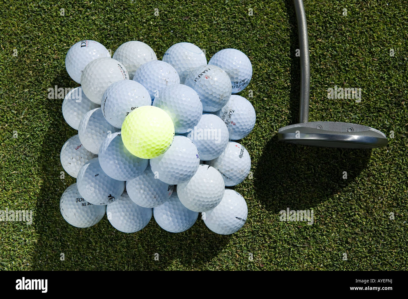 A stack of golf balls and a golf club Stock Photo Alamy