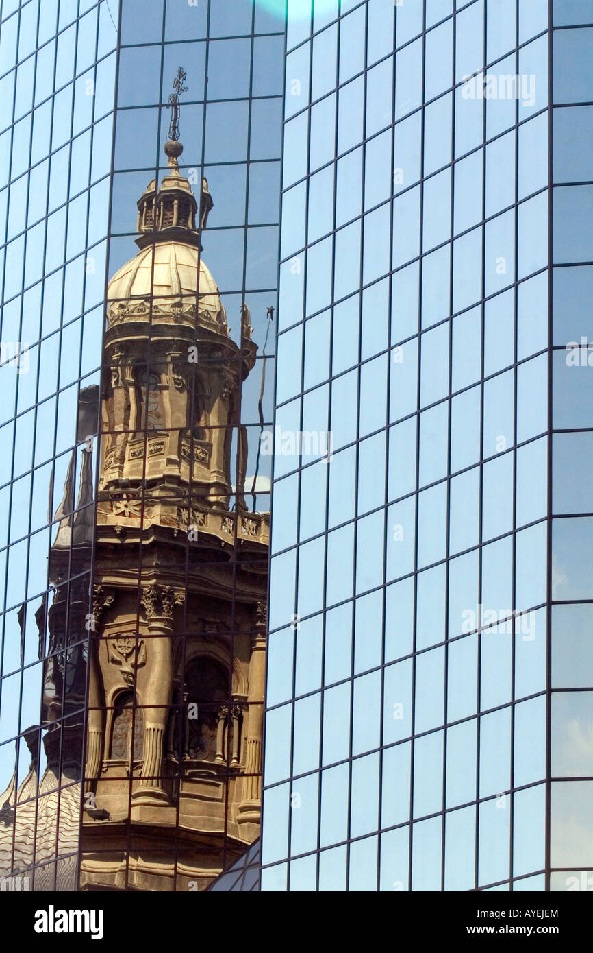Reflection of the Metropolitan Cathedral in a modern office building in the Plaza de Armas in Santiago Chile Stock Photo
