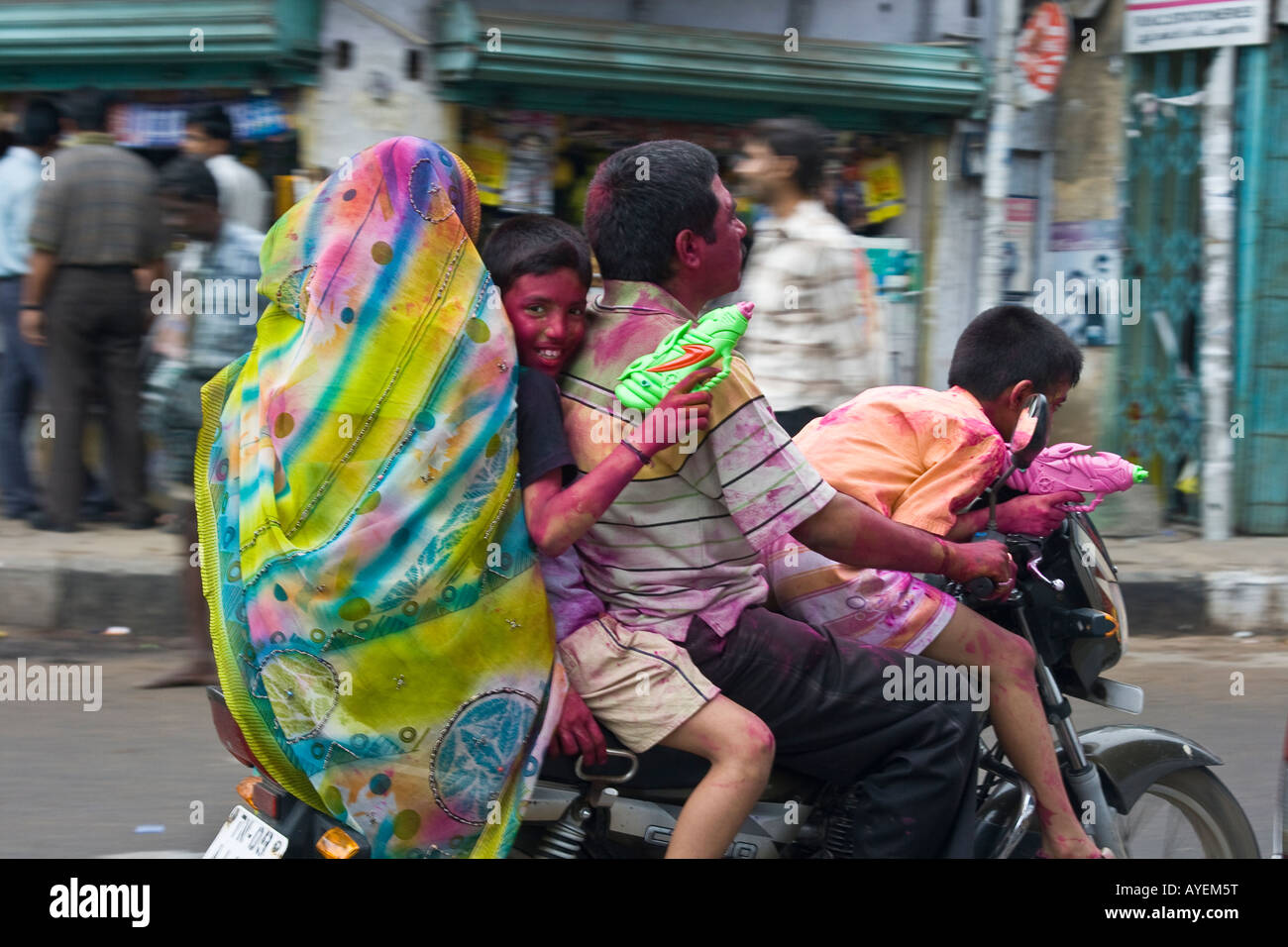 Indian Family on a Motorbike Celebrating the Holi Festival in Chennai South India Stock Photo