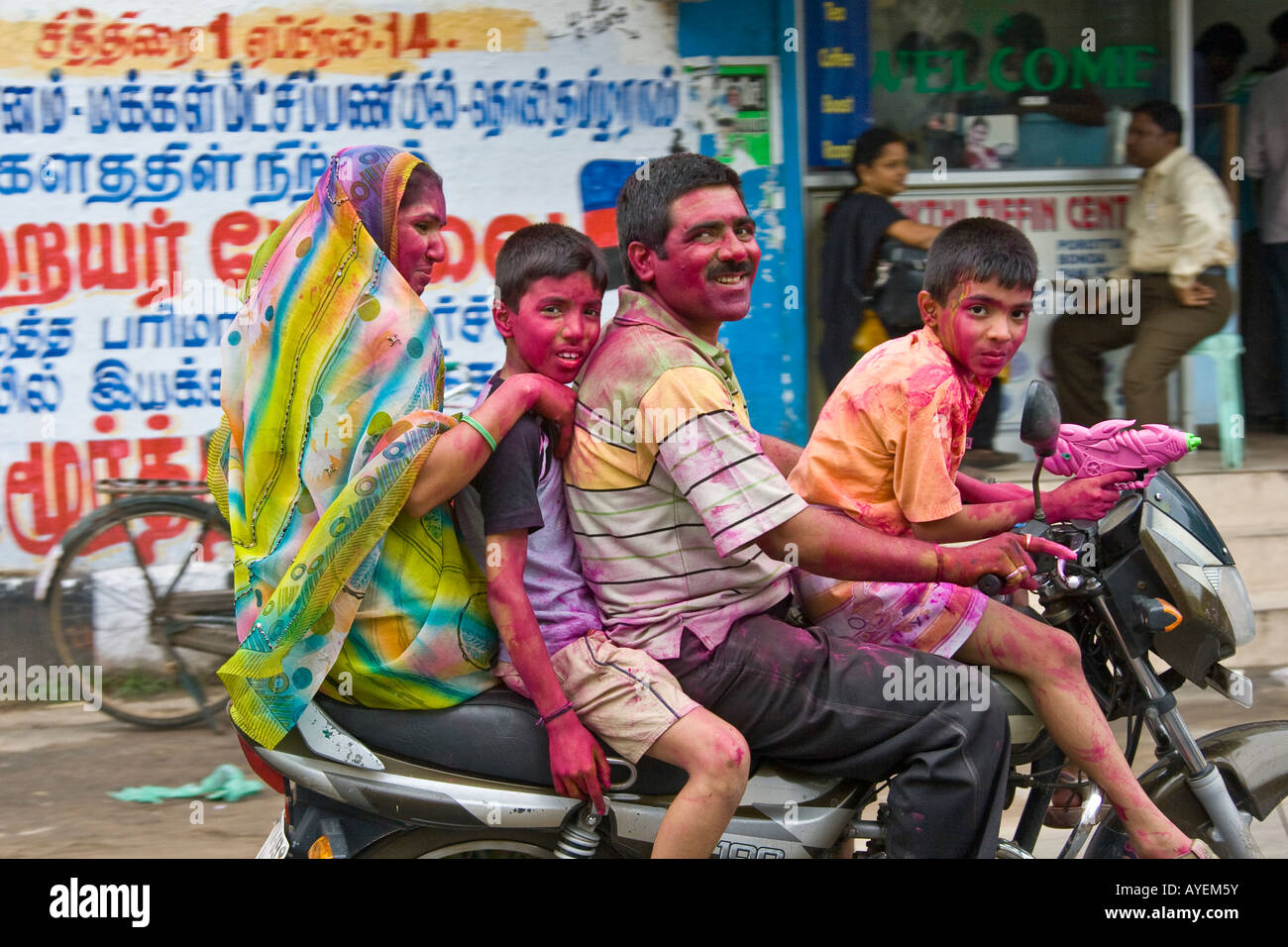 Indian Family on a Motorbike Celebrating the Holi Festival in Chennai South India Stock Photo