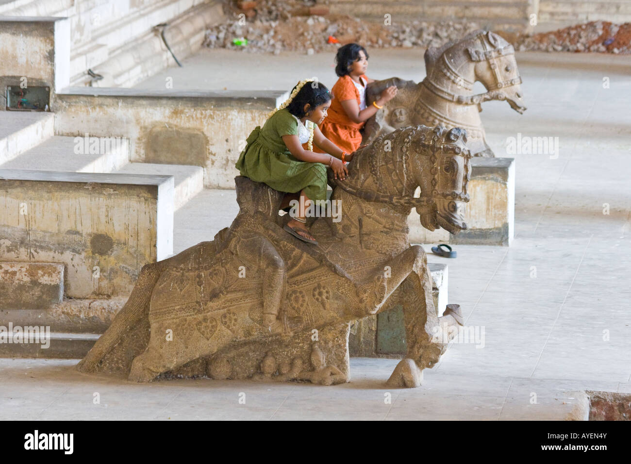 Two Indian Girls Ride Horse Statues Inside the Tirumalai Nayak Palace