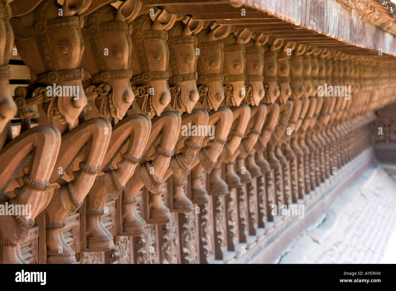 Carved Wooden Horses Lining the Outside of Puthe Maliga Palace Museum in Trivandrum South India Stock Photo
