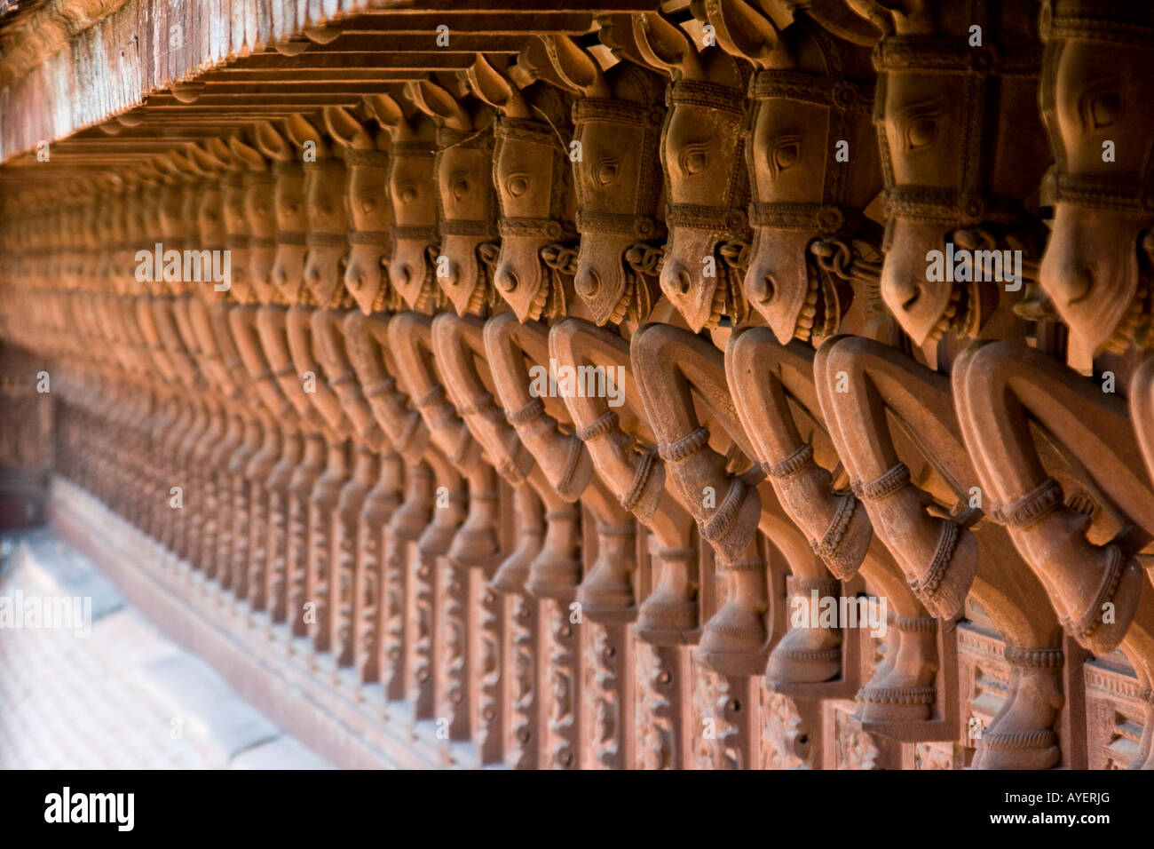 Carved Wooden Horses Lining the Outside of Puthe Maliga Palace Museum in Trivandrum South India Stock Photo