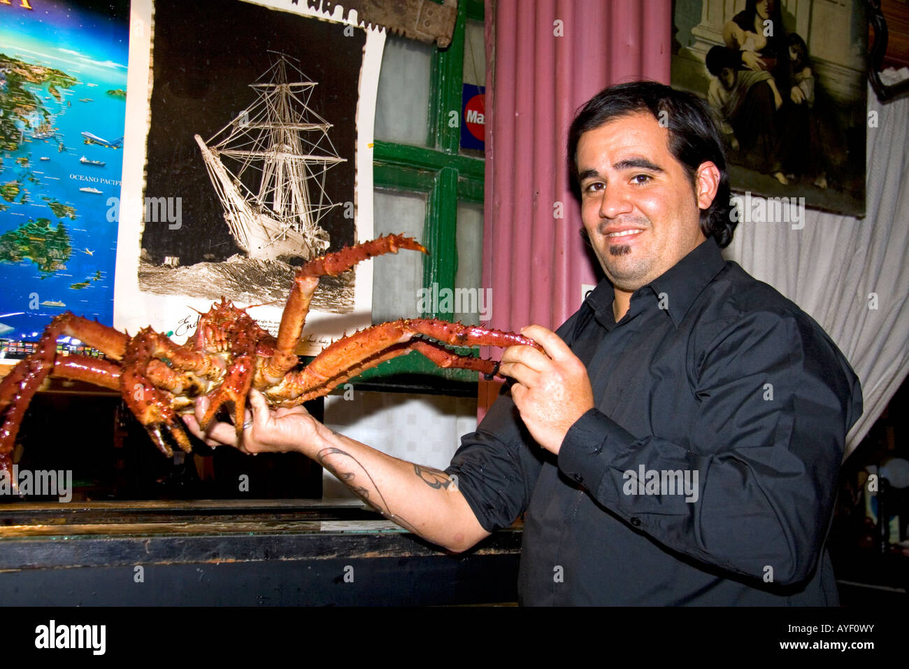 Waiter holding a king crab at a seafood restaurant in Ushuaia Argentina
