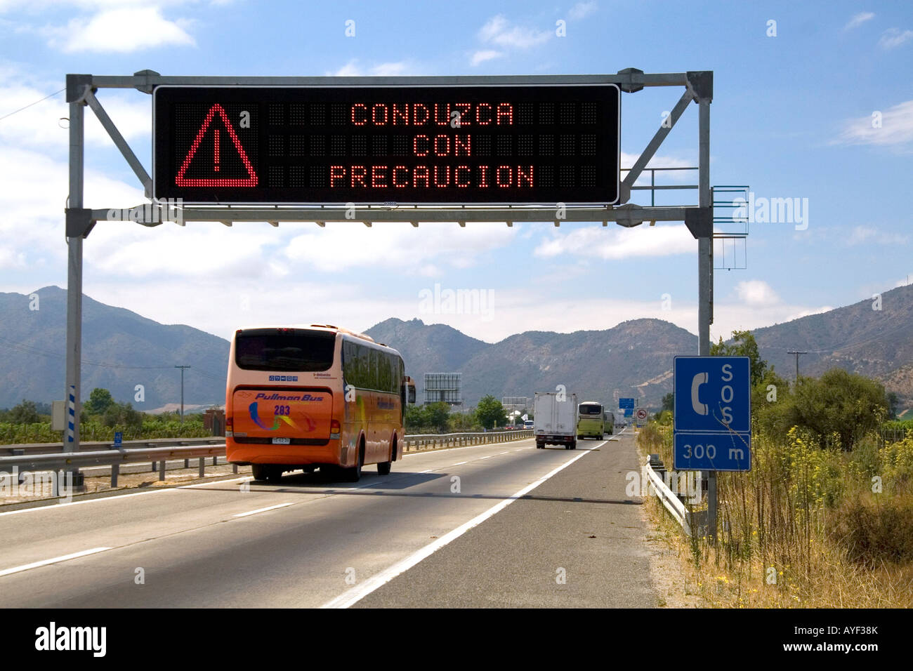 Spanish language road sign reads Drive With Caution near Santiago Chile Stock Photo