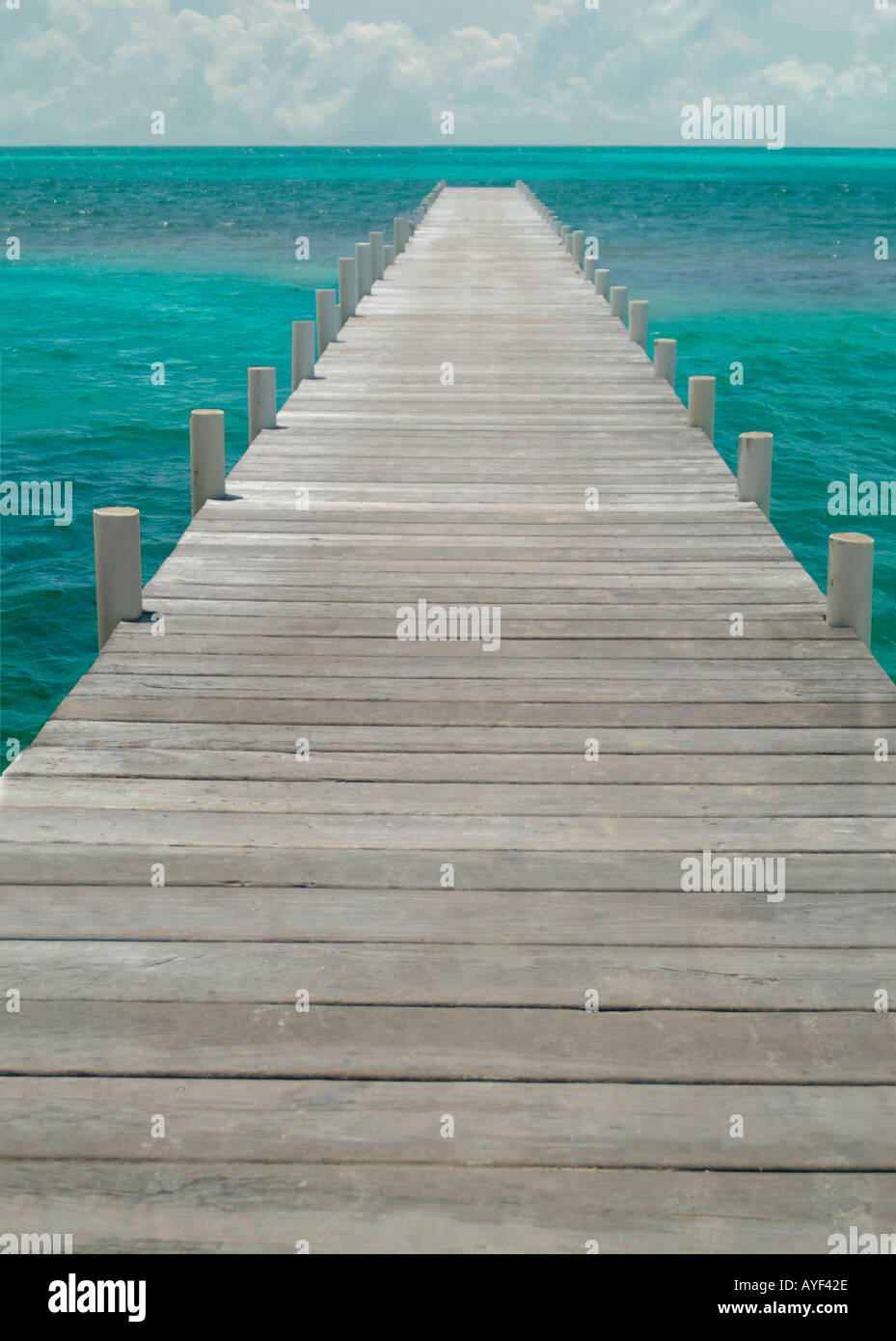 A long wooden pier juts into the Caribbean Sea Stock Photo