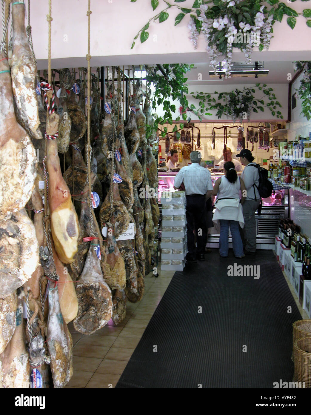 hams hanging in a specialist butcher in Pletzia near Bilbao Basque Spain Stock Photo