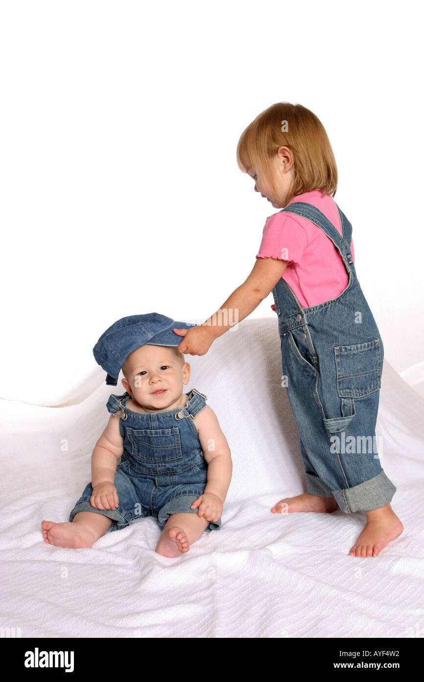 girl putting hat on baby Stock Photo Alamy