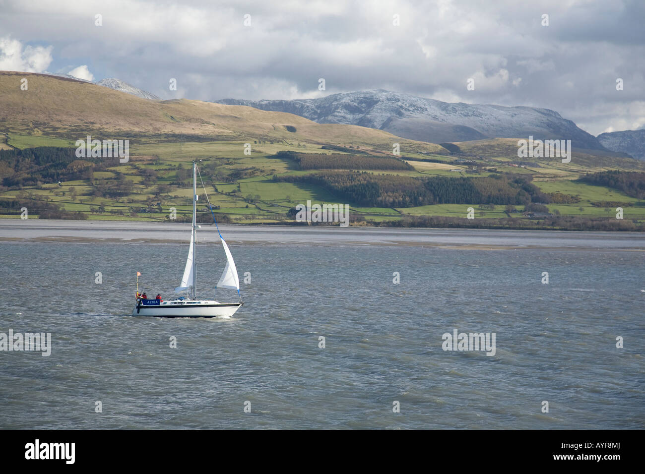 Yacht sailing in the Menai Strait between Beaumaris Anglesey and mainland north Wales, United Kingdom Stock Photo