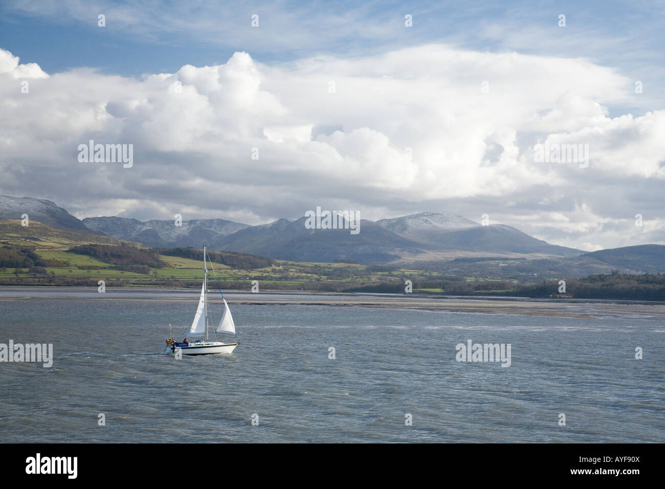 Yacht sailing in the Menai Strait between Beaumaris Anglesey and mainland north Wales, United Kingdom Stock Photo