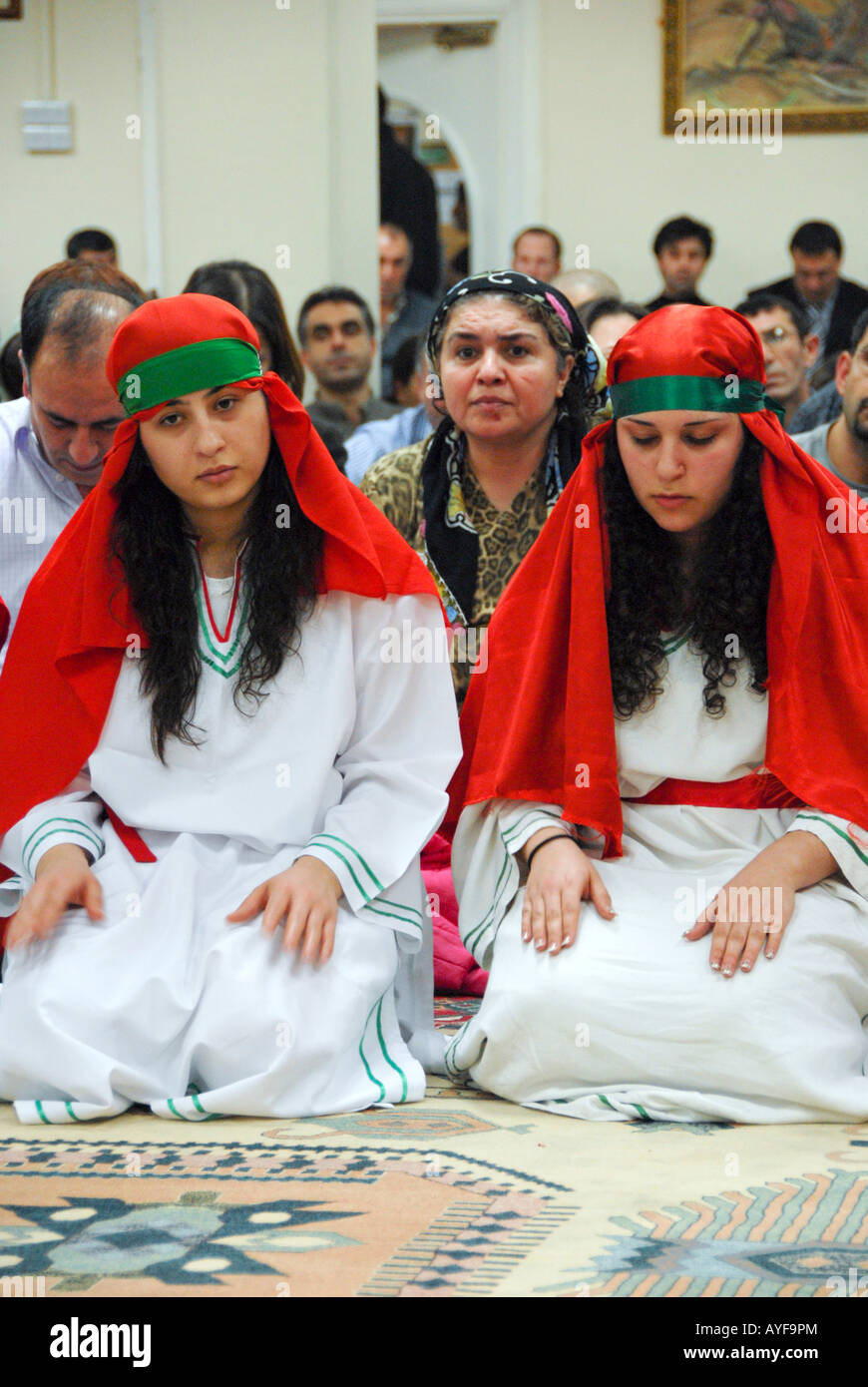 TWO YOUNG ALEVI FEMALE DURING RELIGIOUS CEREMONY,IN ALEVIS CULTURAL CENTER Stock Photo