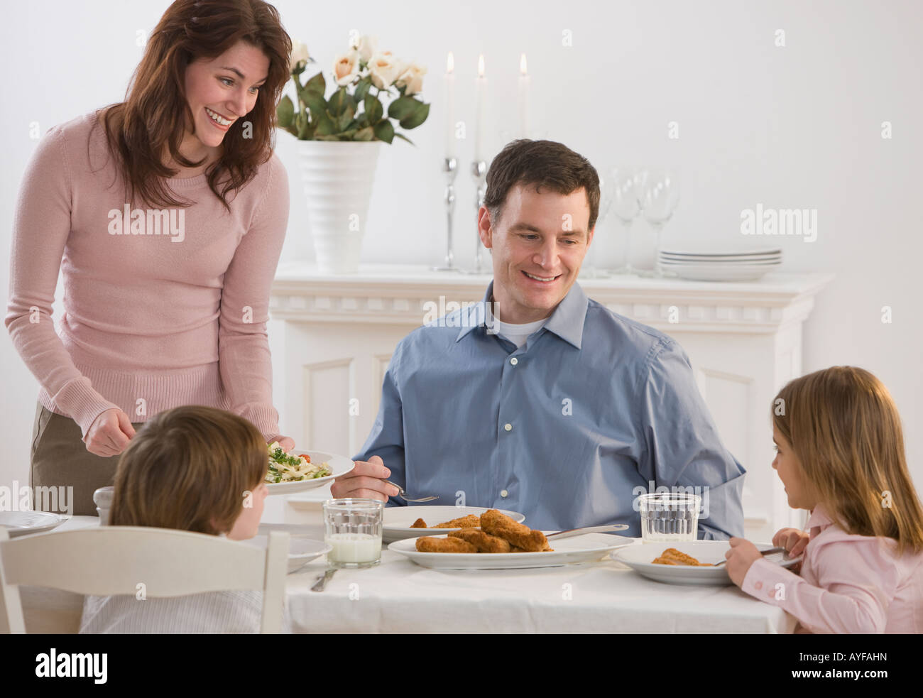 Family eating at dinner table Stock Photo