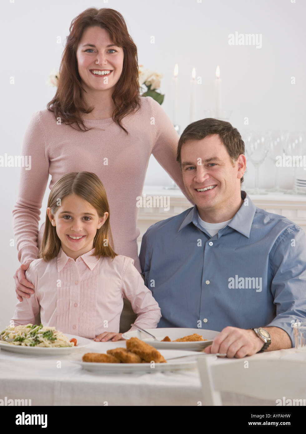 Portrait of family at dinner table Stock Photo - Alamy