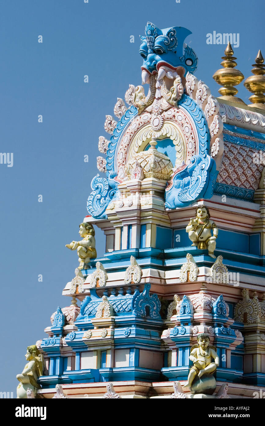 Indian gopuram temple architecture against a bright blue sky, in the South Indian town of Puttaparthi Stock Photo