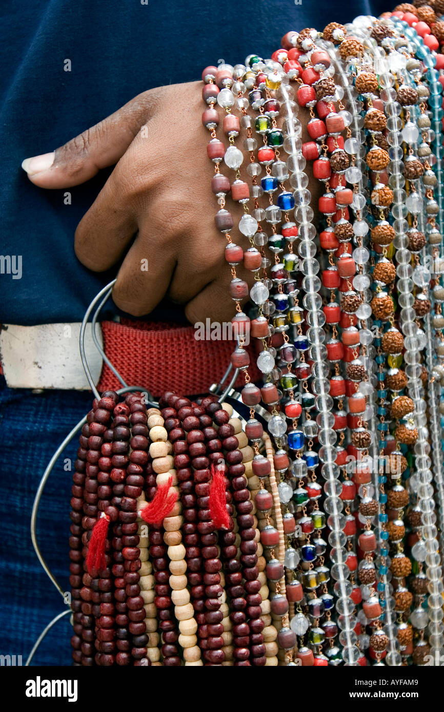 Indian man selling prayer beads wrapped around his arm. Andhra Pradesh, India Stock Photo