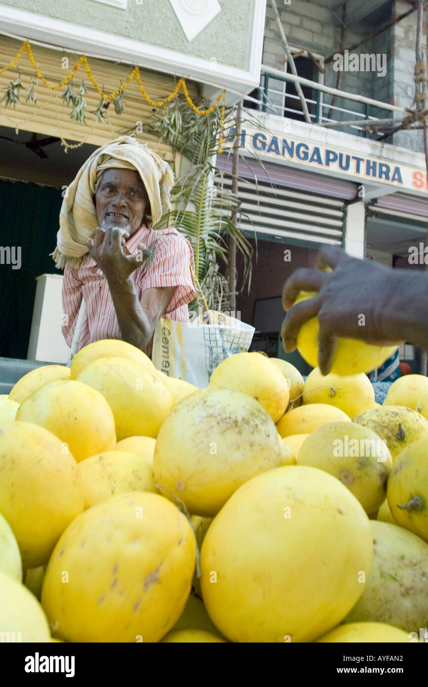 Old Indian man begging for fruit on the street. Andhra Pradesh, India Stock Photo